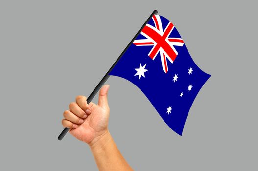 Hand holding australiaflag isolated on white background