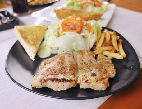 Close up of pork steak on a white plate