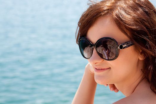 portrait of a beautiful young girl who rests on the coast