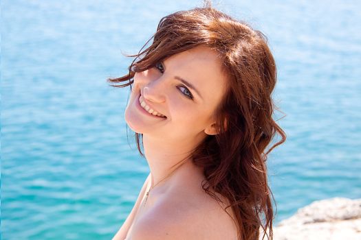 portrait of a beautiful young girl who rests on the coast