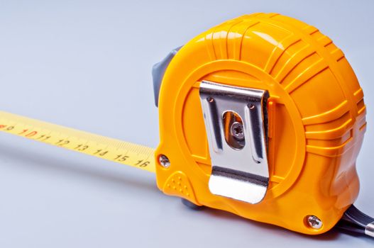 Extended yellow tape ruler on white background