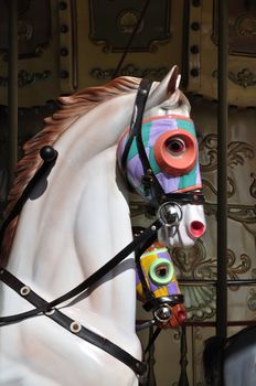 Close-up of merry go round horse with colorful head.