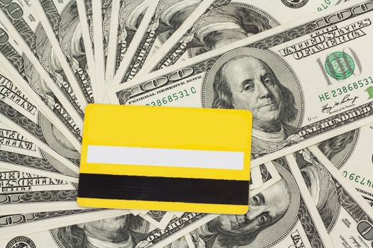 yellow plastic card against dollar