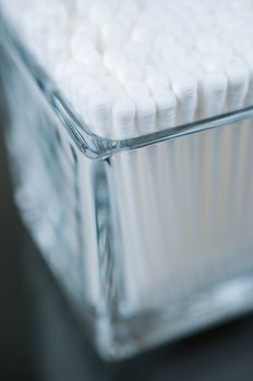 Cotton buds in a glass corner view close up