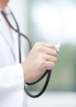 Close-up photo of the doctor hand holding stethoscope