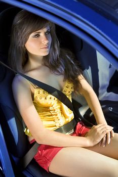 beautiful girl in car fastened by seat belt