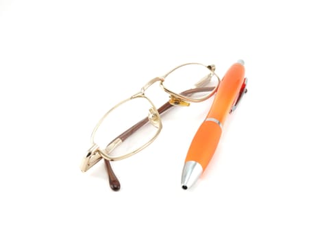 Glasses and orange pen over white