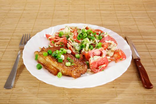 Fried meat with vegetable garnish