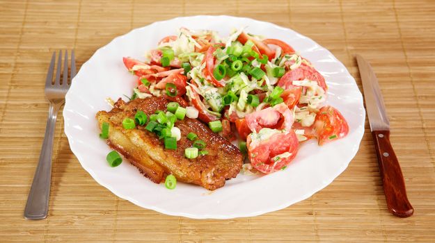 Fried meat with vegetable garnish