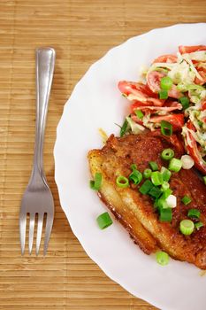 Fried meat with vegetable garnish