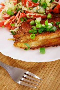 Fried meat with vegetable garnish