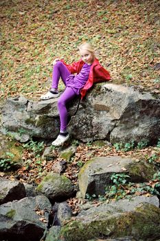 Portrait of Little Girl in Autumn Park