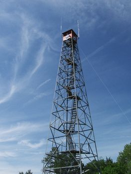 A fire tower stands over a foreston the watch for forest fires