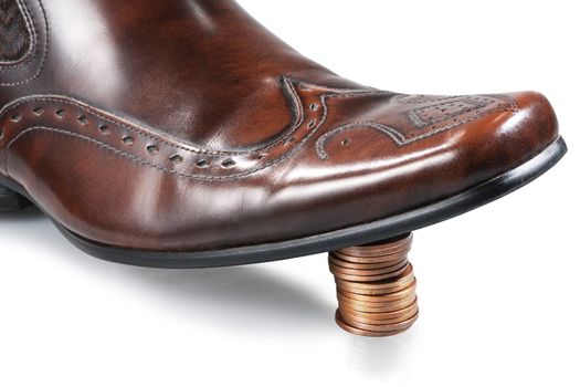 Shiny businessman shoe, step on the stack of coins. Isolated.