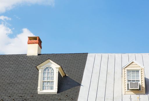 Two Windows and a Chimney on two continuous house roofs