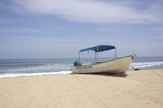 a white boat on a tropical beach 