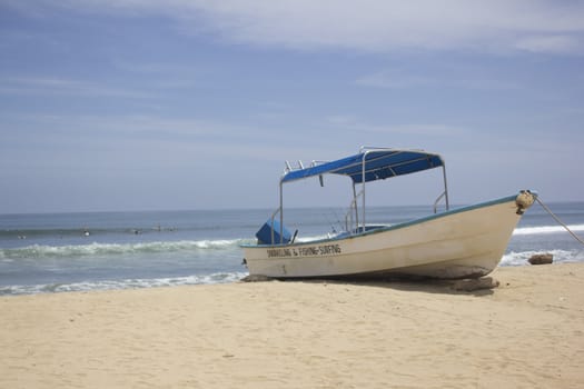 a white boat on a tropical beach 