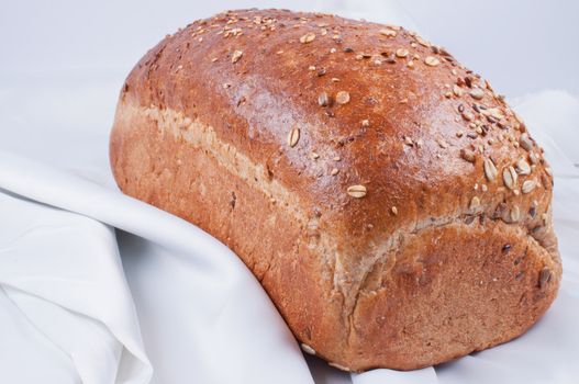 loaf of bread on white linen close up