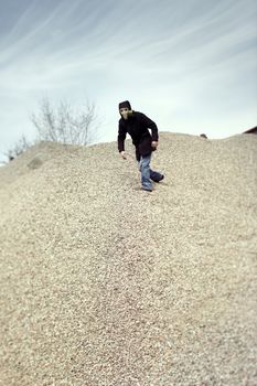 Human in gas mask running in the desert after doomsday