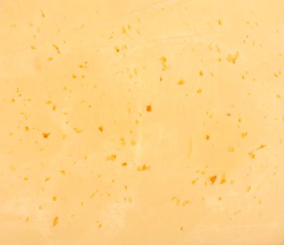 Background of fresh yellow Swiss cheese with holes 