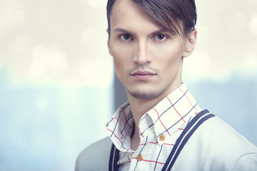 Attractive young man in modern clothes at his office