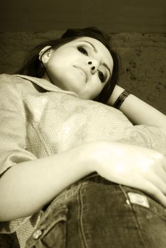 Low closeup brown cyanotype of a girl laying down