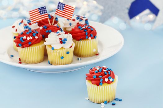 American patriotic themed cupcakes for the 4th of July. Shallow depth of field with selective focus on cupcake in foreground.
