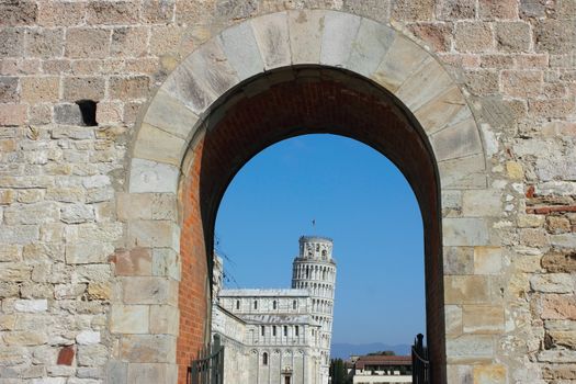 Entrance to piazza dei miracoli with the leaning tower at the back in Pisa, Italy