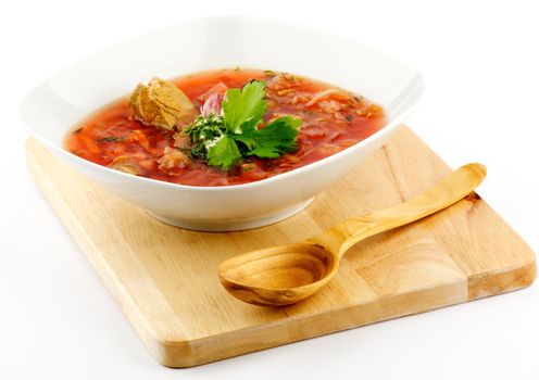 Ukrainian and russian national homemade red soup Borscht on wooden cutting board