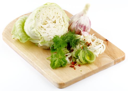 Set of cabbage and raw vegetables close up on wooden background