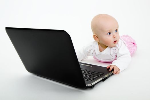 funny baby girl with laptop on white background