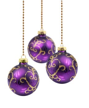 Three purple gold Christmas balls hanging on white background isolated