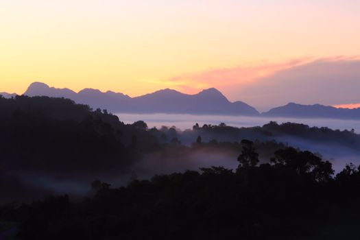 Dramatic clouds with mountain and tree in the morning