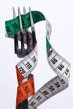 fork with tape measure, illustration for health and  nutrition with tape measure, illustration for health and  nutrition