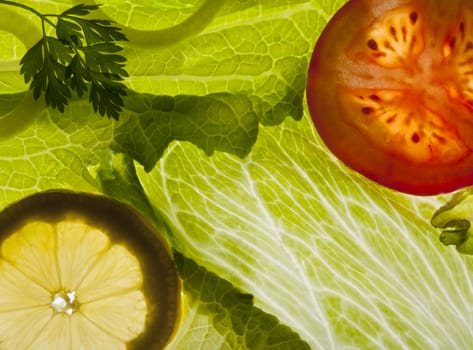 Iceberg salad, lemon and tomato as fresh food background