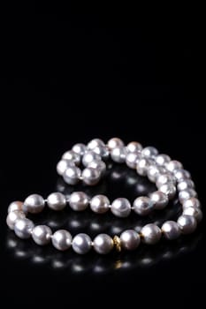 grey pearls on black background