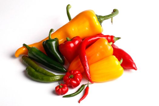 various peppers on white background
