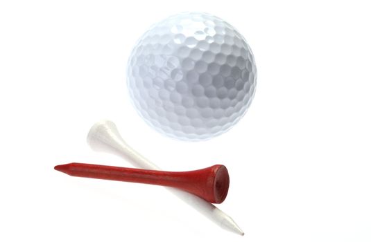 Golf ball and red and white wooden tees