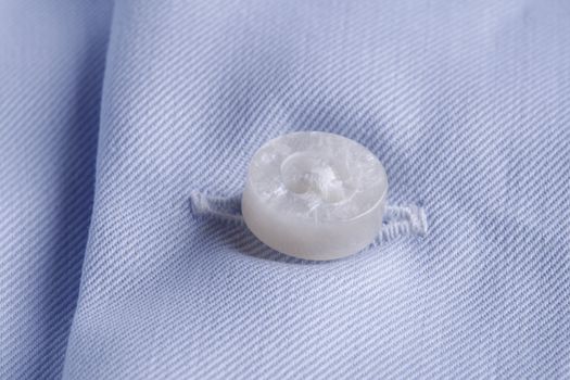 Textile background. close-up of a button and buttonhole on a business shirt