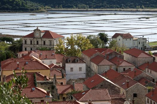 Medieval Croatian town of Ston with salt production lakes in background