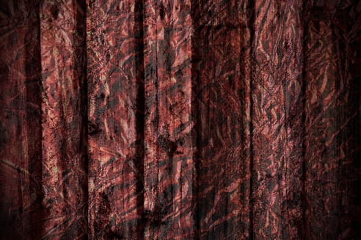 Grungy dramatic old exterior rough wood plank with red foil textured applied to create great scary dark background and texture.