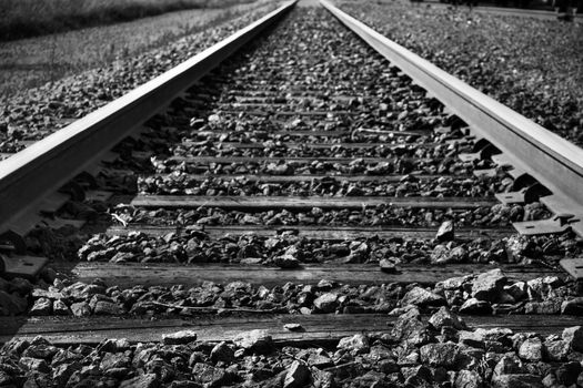 Dramatic black and white rendering of train tracks with diminishing perspective, great background.