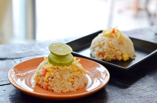 two dish of  fried rice on wood table 