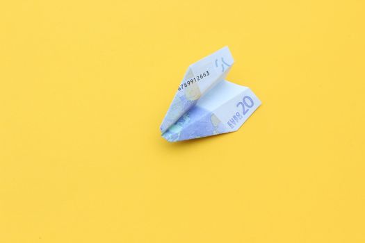 nice conceptual image of money airplane on yellow background