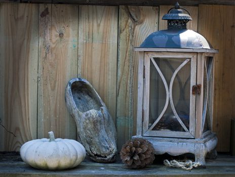 stil life on a table with light and wooden shoe