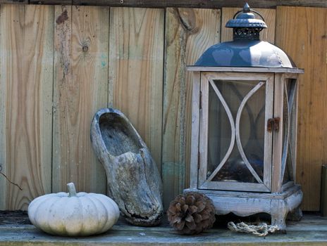 stil life on a table with light and wooden shoe
