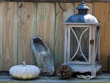 stil life on a table with light and wooden shoe