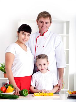 portrait happy family is cooking dinner together