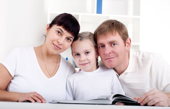 Family reading a book together, a family vacation