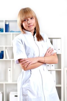 portrait of a beautiful woman doctor standing with folded arms